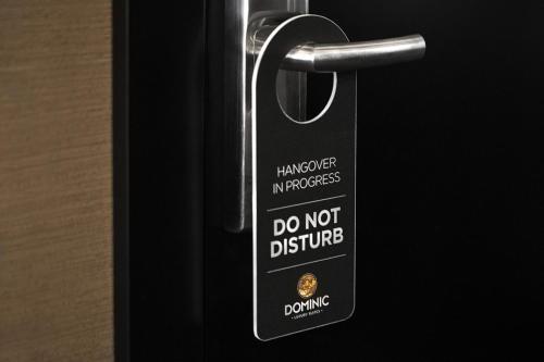 a do not disturb sign is attached to a door at Dominic Smart & Luxury Suites - Republic Square in Belgrade