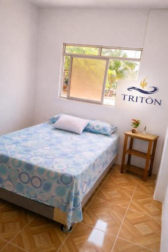 a bedroom with a bed in a room at Casa de Playa Triton in Máncora
