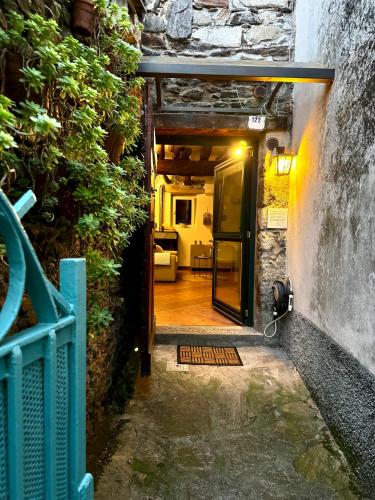 an entrance to a house with a door open at Casa Zita Cozy • AC near Lake Como by Gottschalk in Olgiasca