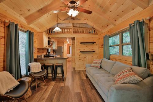 a living room with a couch and a kitchen at River Cabin Hot Tub & Swim Spa Near Downtown in Chattanooga