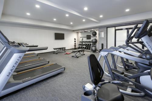 a gym with treadmills and elliptical machines at Courtyard Mobile in Mobile