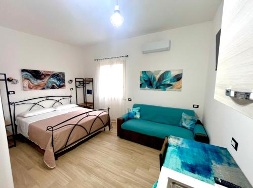 a bedroom with a bed and a couch at Casetta Marisù in Partinico