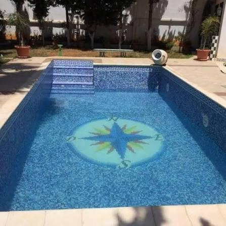 a blue swimming pool with a frisbee in the water at روف كامل خصيصا لك in Madīnat ash Shurūq