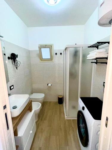 a bathroom with a sink and a toilet and a shower at Casetta Marisù in Partinico