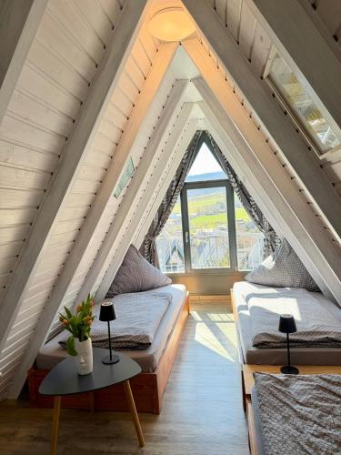 a room with two beds in the attic at Ferienhaus in der Rhön Sitzmann in Bischofsheim an der Rhön