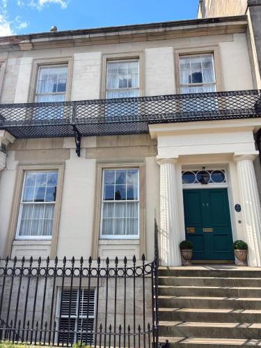 a house with a green door and stairs at Hanover House in Edinburgh
