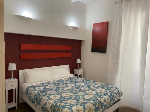 a bedroom with a bed and two night stands with lamps at Palazzo della Poesia Casa Vacanze in Salerno