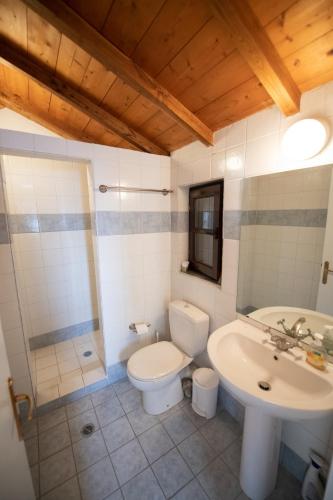 a bathroom with a toilet and a sink at Aegean Panorama in Klíma