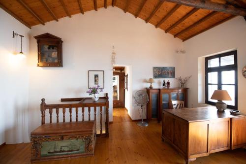 a living room with a table and a wooden floor at Aegean Panorama in Klíma