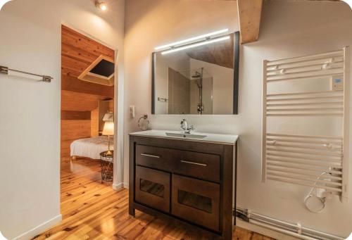 a bathroom with a sink and a mirror at Villa Marisa in Ax-les-Thermes