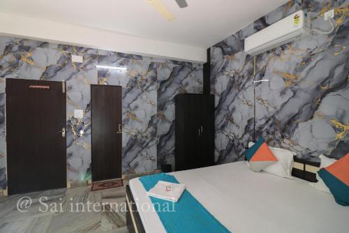 a room with a marble wall with a table at Sai International Guest House in kolkata