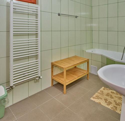 a bathroom with a sink and a toilet and a table at Muskatli Villa in Sovata