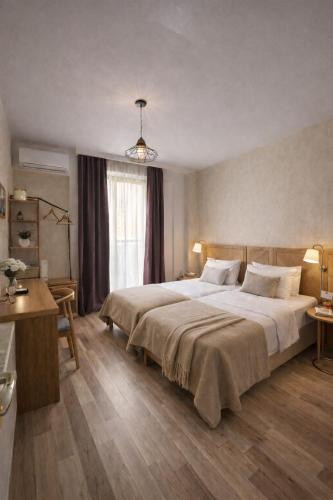 a bedroom with a large bed and a window at Amber Boutique Hotel in Tbilisi City