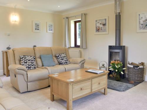 a living room with a couch and a coffee table at The Oaks - Uk11270 in Lanreath