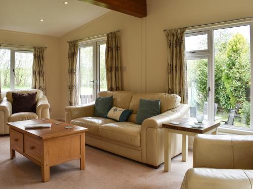 a living room with a couch and a table at The Lodge - Uk11271 in Lanreath