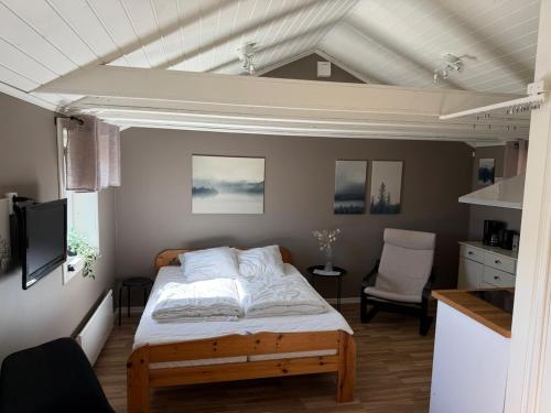 a bedroom with a bed and a white ceiling at Guest House Stare in Strömstad
