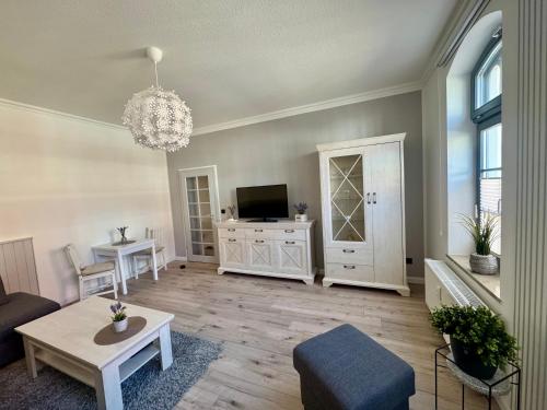 a living room with a couch and a tv at Ferienwohnung Muranko in Bad Doberan