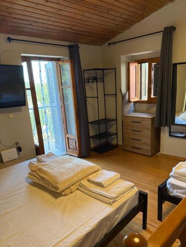 a bedroom with a bed and a tv in a room at Kathryns apartment in Sinarádes