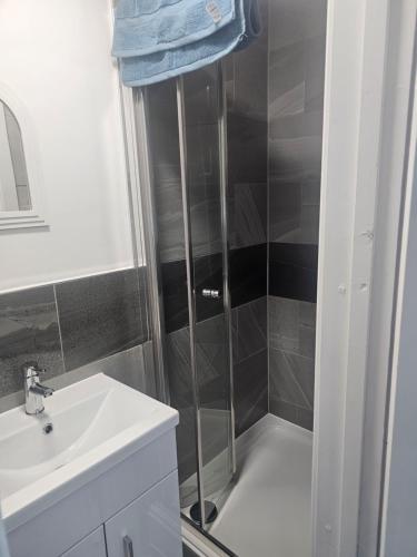 a bathroom with a shower and a sink at Rose Acre Home Basildon in Basildon