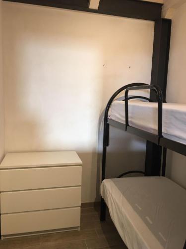 a bunk bed room with two bunk beds and a dresser at Casa Vacanza Piazza Gramsci 1 in Scanzano