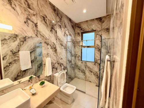 a bathroom with a sink toilet and a shower at Shelton Rezidor House F-8 Islamabad in Islamabad