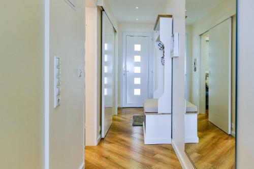 a hallway with white walls and wooden floors at Am Sahlenburger Strand AS23 in Cuxhaven