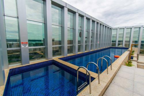 a swimming pool on the roof of a building at Vision Hotel em Brasília 59854 in Brasília
