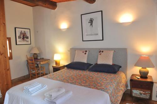 a bedroom with a bed with towels on it at Loft Apartment , La Terrasse Centre Ville d'Arles, in Arles