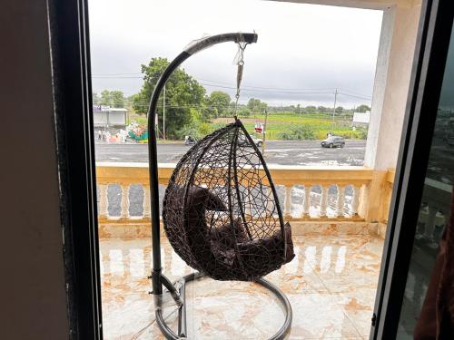 a bird cage sitting on a window sill at Rajmahel in Barvāla