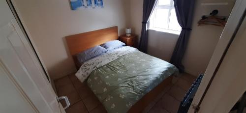 a small bed in a bedroom with a window at Ocean Bliss in Bundoran