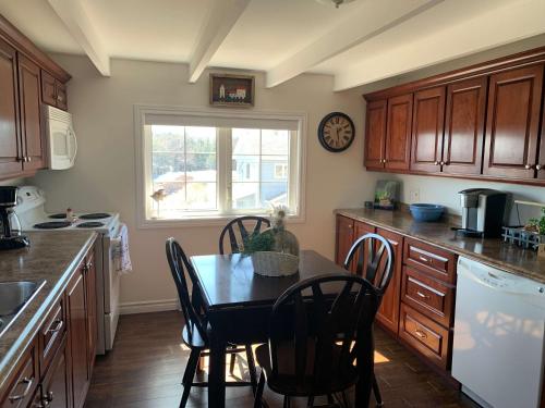 a kitchen with a table and chairs and a window at Salty B'y & Nook in Twillingate