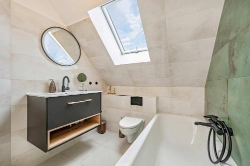 a bathroom with a sink and a toilet and a window at FeWo Dock12C in Kölpinsee