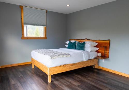 a bedroom with a large bed with blue pillows at Hot Tub Nights & Mountain Mornings PÜR in Golden