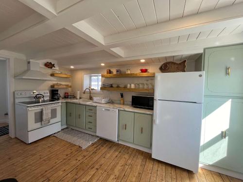 a kitchen with white appliances and a white refrigerator at Wild Cove Retreat in Twillingate
