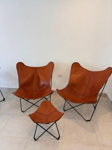 a group of three leather chairs in a room at Casa Iturraspe in Reconquista