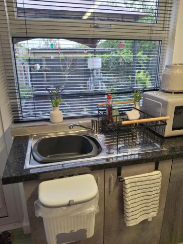 a kitchen counter with a sink and a window at Nett'Als Lodge Studio Apartment in Derby
