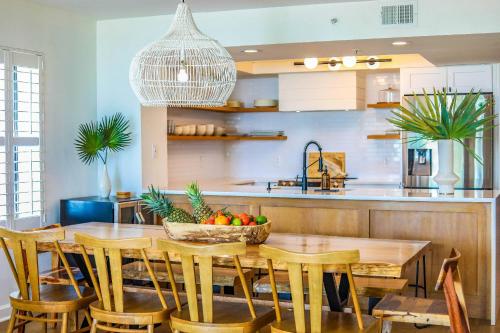 a kitchen with a wooden table with a bowl of fruit at Sunshine Daydream in Folly Beach