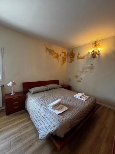 a bedroom with a bed with two towels on it at Cascina Buren in Brescia