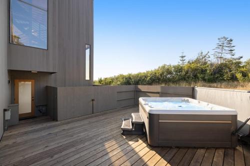 a hot tub on the deck of a house at Breakers Retreat in Sea Ranch