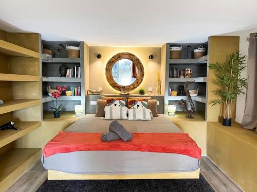 a bedroom with a large bed with a large mirror at Seven Elements Appart in La Gaulette