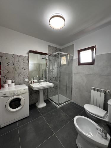 a bathroom with a shower toilet and a sink at Cascina Buren in Brescia