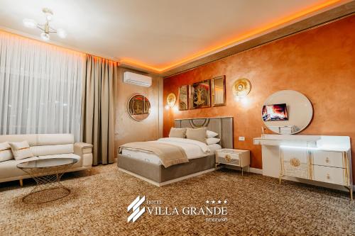 a bedroom with a bed and a vanity and a mirror at HOTEL Villa Grande in Bugojno