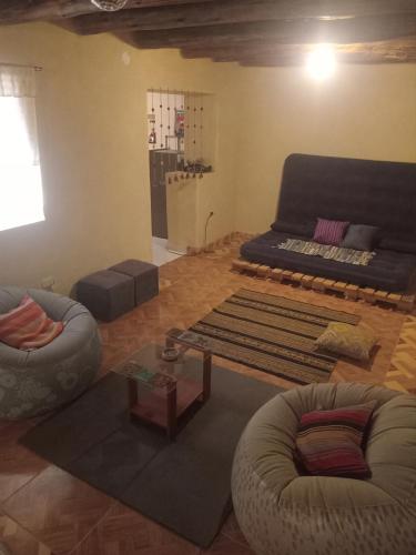 a living room with two chairs and a couch at Small House Pisac in Pisac
