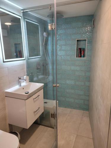 a bathroom with a shower and a toilet and a sink at BEM MINI STUDiO in Budapest