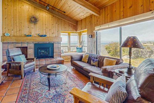 a living room with a couch and a fireplace at Windrow Retreat in Sea Ranch