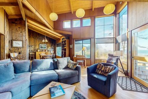 a living room with a blue couch and chairs at Meyer Getaway in Sea Ranch