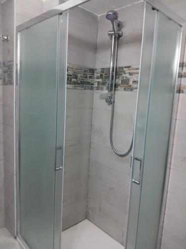 a shower with a glass door in a bathroom at Il Centro in Tergu
