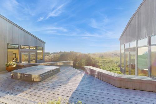 a large house with a bed on a deck at Del Mar Meadow in Sea Ranch