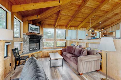 a living room with a couch and a fireplace at Stoney House in Sea Ranch