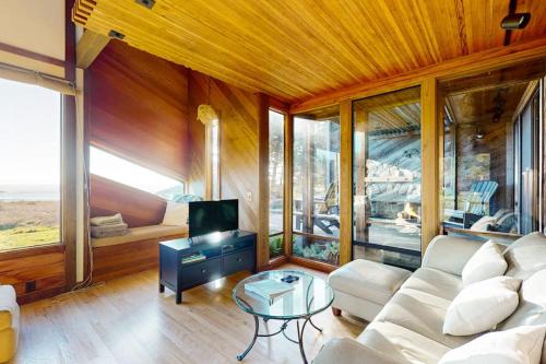 a living room with a white couch and a tv at Vista Grande in Sea Ranch